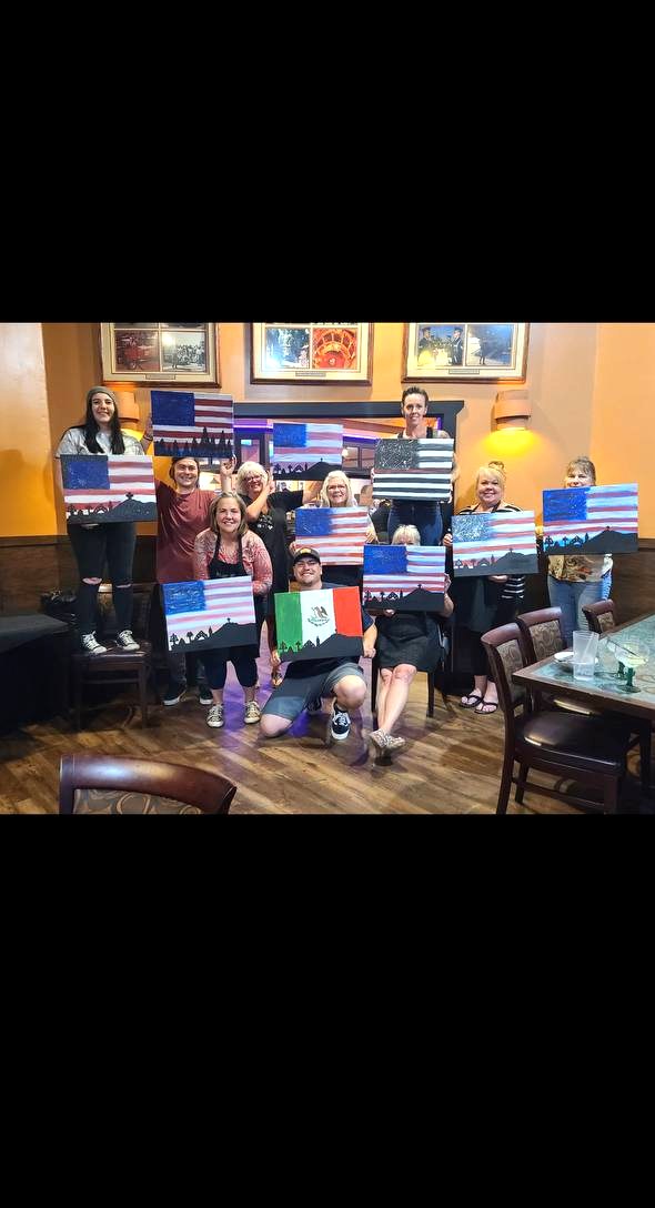 Large group holding flag paintings